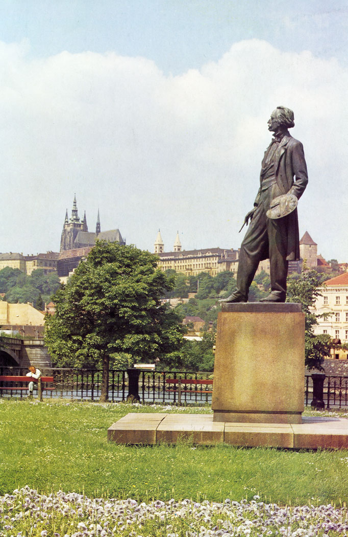 The embankment by the House of Artists was laid out in 1875. The statue of painter Josef Manes, made by Bohumil Kafka, was placed on the site in 1951.